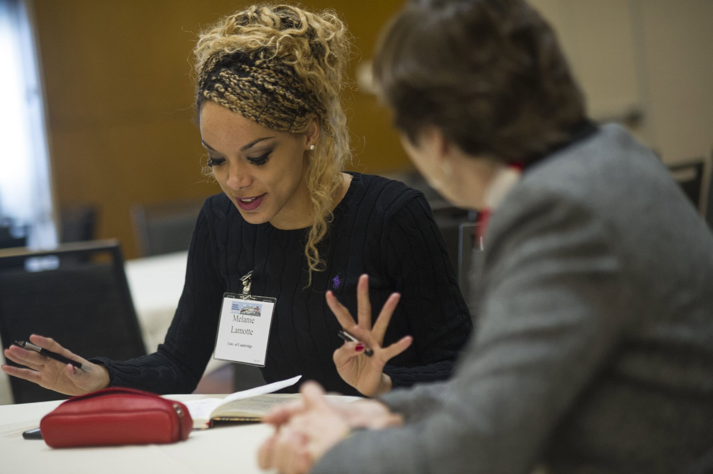 Woman looking at a paper doing workshop with group Woman looking at a paper doing workshop with group