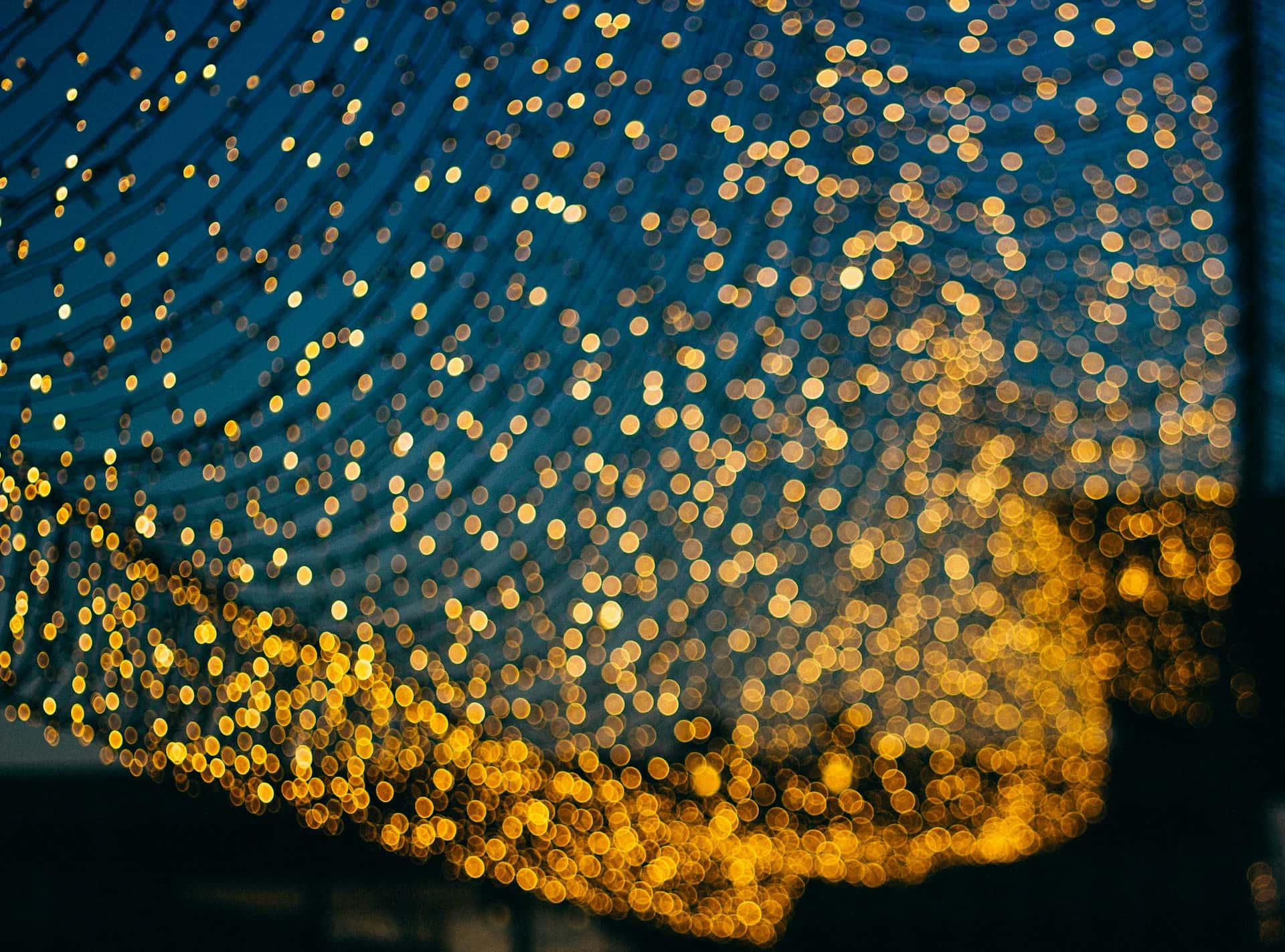 Many small yellow circles splashed across a blue and black background